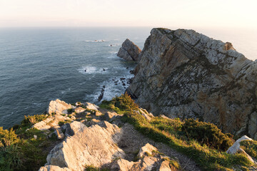 Fototapeta na wymiar Peñas Cape cliffs at sunrise in Asturias, north of Spain