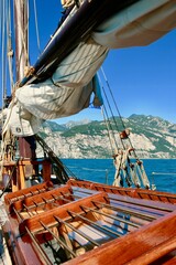 Sea regatta. Yacht floating on the water straight to the seashore on bright sunny day. Yachting in the sea. Ocean ​​view from the deck of the yacht. Yachting sport. 
Sailing yachts. Sea transport.