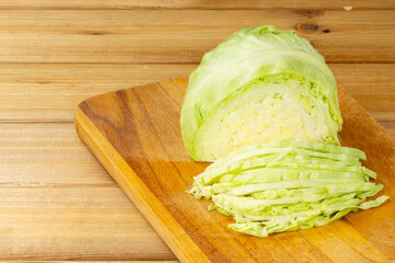 Sliced cabbage on a cutting board. Wooden background