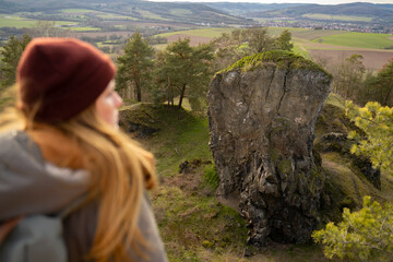 woman wanderer enjoys view above valley