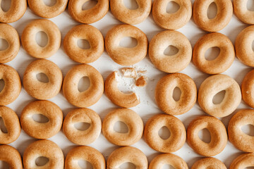 Drying or mini round bagels on a white wooden background. Top view. Copy, empty space for text
