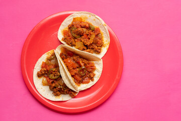 Mexican chorizo tacos on pink background