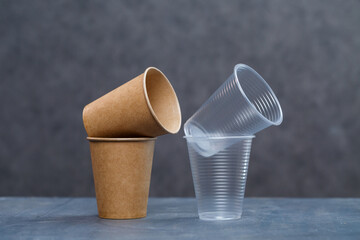 Eco-friendly disposable tableware made of bamboo wood and paper on a gray background. Plastic dishes and cutlery. Caring for the environment. Recycling problem. safe planet, environmental concept.