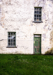 Old house with weathered green door