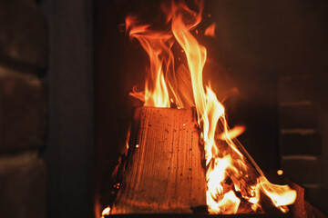 Fireplace with burning wood, closeup view. Winter vacation