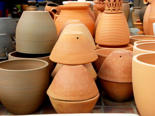 Fototapeta na wymiar A collection of large cone-shaped ceramic flower pots. Red clay flower pots.