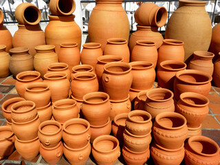 A collection of large and small ceramic flower pots. Red clay flower pots.
