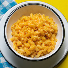 Creamy mac and cheese on yellow background