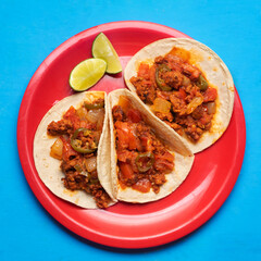 Mexican chorizo tacos on turquoise background