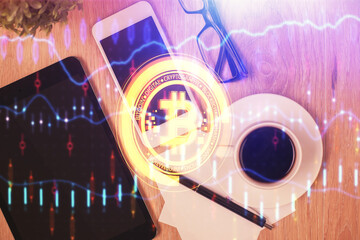 Double exposure of blockchain theme hologram over table with phone. Top view. Crypto technology...