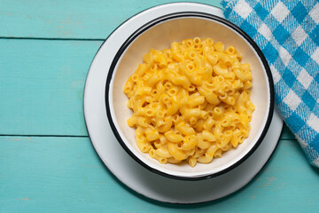 Creamy mac and cheese on turquoise background
