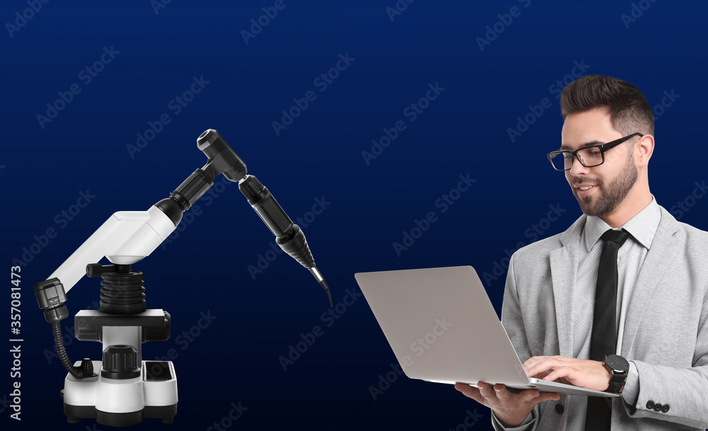 Poster engineer controlling electronic laboratory robot manipulator with laptop on blue background. machine