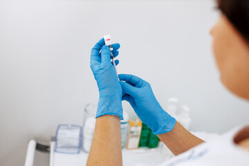 A doctor, a nurse, a scientist uses a vaccine against a virus, a coronavirus, or the flu. The...