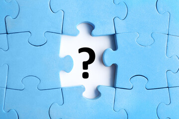 Light blue puzzle with missing piece and question mark on white background, top view