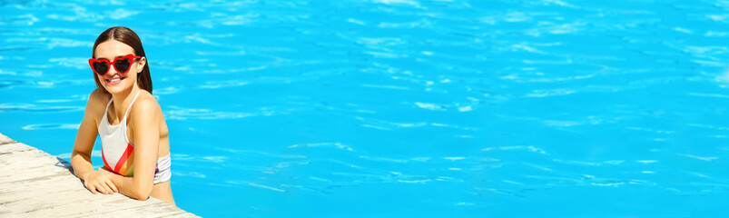 Beautiful young woman in swimming pool on sunny day, space for text. Banner design