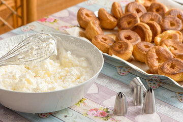  kitchen table preparation of pastry filled with cream