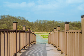 Wooden foot bridge under blue sky