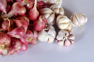 A group of garlic and red onion on white background