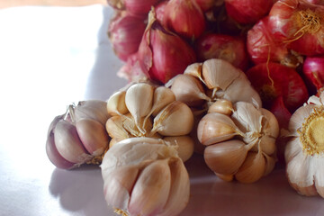 A group of garlic and red onion on white background