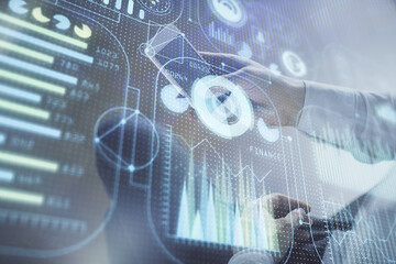 Double exposure of man's hand holding and using a digital device and data theme drawing. Technology concept.