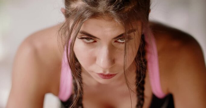 Close up shot of slimming caucasian girl doing gym routine. Fit model does push ups as a part of crossfit training session - healthy lifestyle concept 4k footage