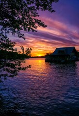 View of the Müggelspree lake and the boathouse Spreearche with a beautiful and dramatic sunset in...