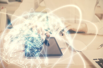 Double exposure of business theme sketch hologram and woman holding and using a mobile device.