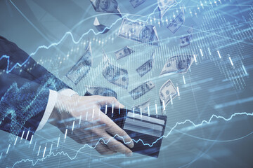 Multi exposure of financial graph drawing hologram and USA dollars bills and man hands. Analysis concept.