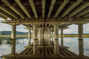 Fototapeta na wymiar Bridge reflection in the river below.