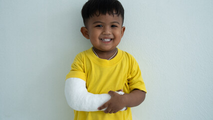 Cute boy hand bone broken from accident with arm splint