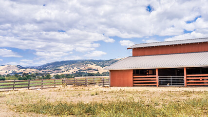 Landscape in a rural area of South San Francisco Bay, with wooden barn surrounded fields and...
