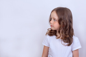 Beautiful cute girl looks away on a white background
