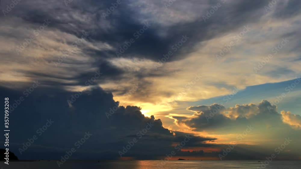 Wall mural Epic sunset time lapse of moving clouds above the ocean