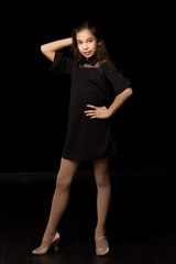 Fototapeta premium Beautiful young teen girl studio photo on black background