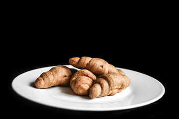 Croissants on a white plate. Fresh bakery