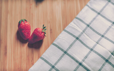 fresh strawberry on wooden background; vintage style