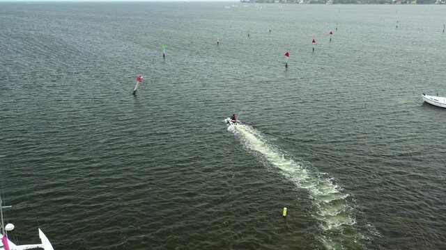 Active tracking drone following a wave runner jetski in the bay