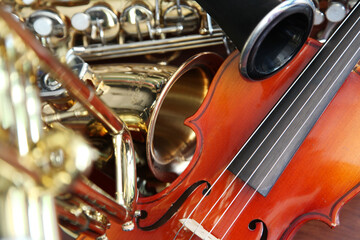 Closeup detail of classical musical instruments; violin, saxaphone,  and clarinet 