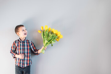 The boy holding flowers.
