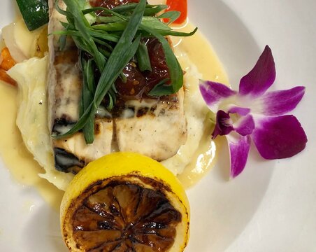 Fine dining mahi mahi dish, with lemon butter sauce, served in a Maui restaurant