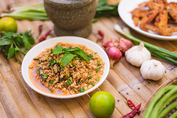 spicy minced meat salad on the wooden table,Thai food.