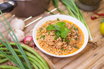 spicy minced meat salad on the wooden table,Thai food.