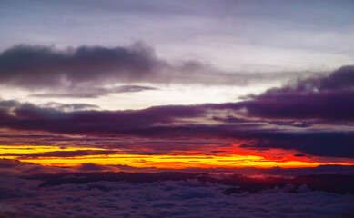 Stunning Colorful Sunset Above The Clouds Over Mountain Peaks