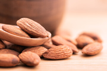 Close up view of almond seed. Almond seeds placed on a wooden floor