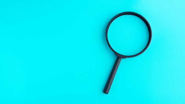 Magnifying glass isolated on blue background
