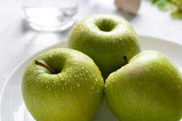 Wet fresh green apples on a table. The concept of organic and healthy food