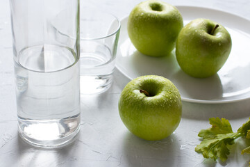 Wet fresh green apples on a table. The concept of organic and healthy food