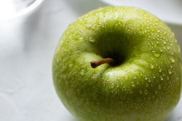 Wet fresh green apples on a table. The concept of organic and healthy food