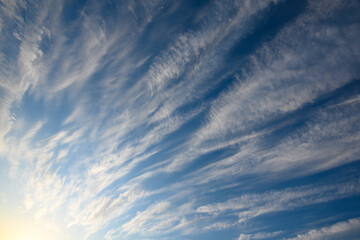 blue sky with feathery white clouds