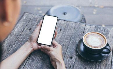 cell phone mockup image blank white screen.woman hand holding texting using mobile on desk at coffee shop.background empty space for advertise.work people contact marketing business,technology